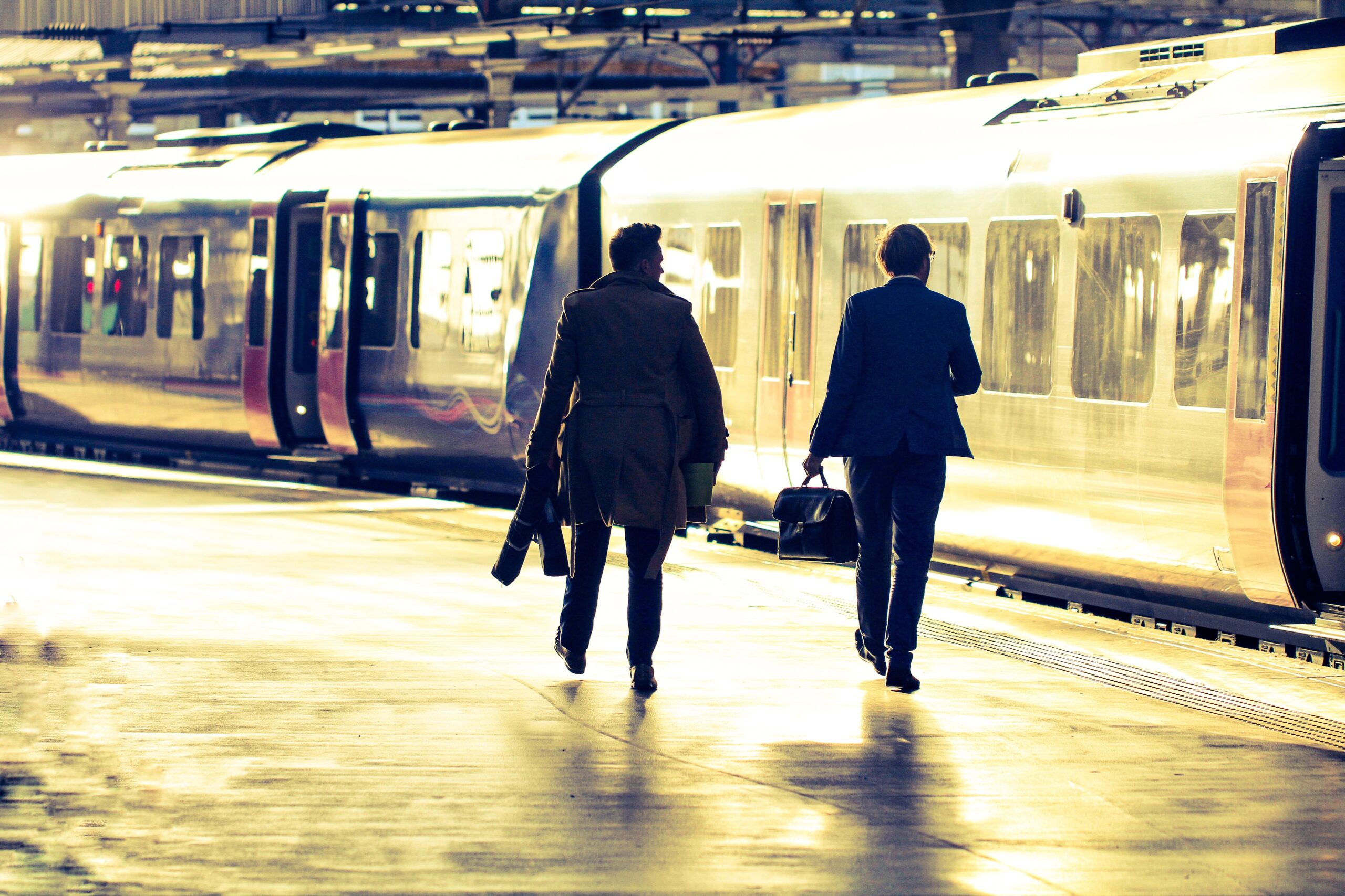 people walking towards a train